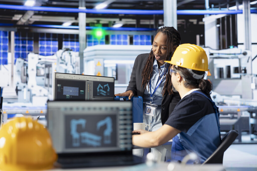 Staff reviewing production processes in a photovoltaic manufacturing facility.