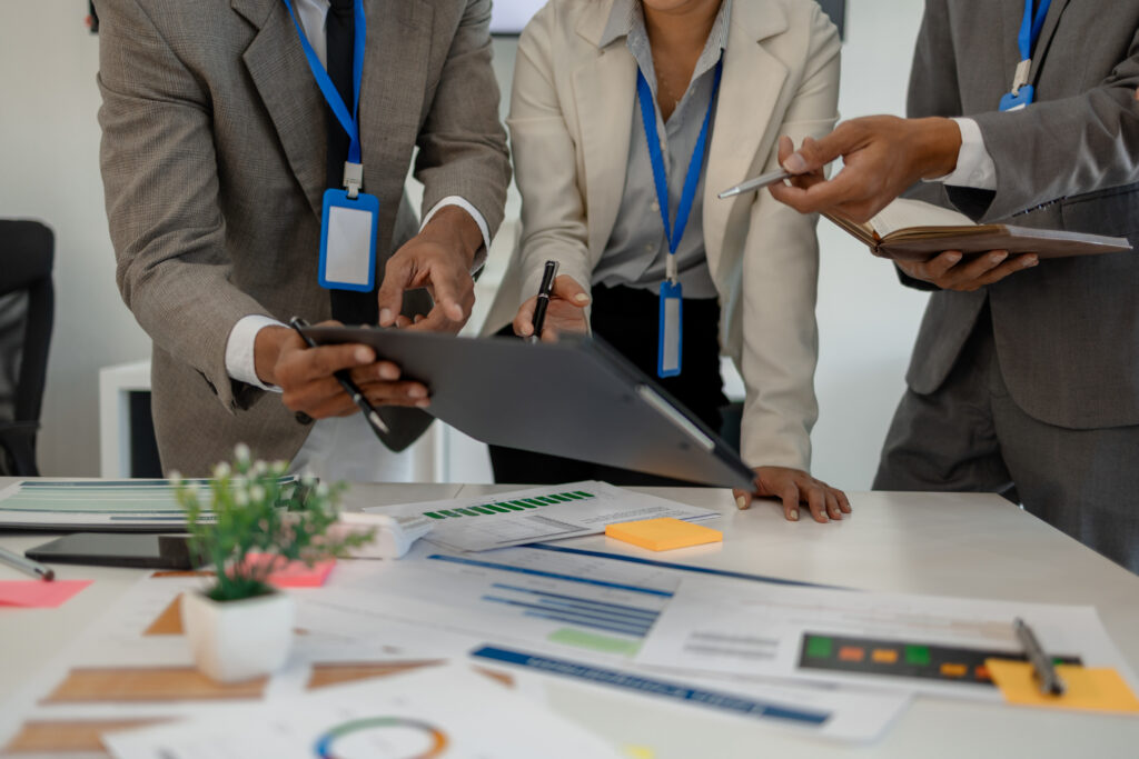 Business professionals collaborating on a project during a team meeting in a modern office.