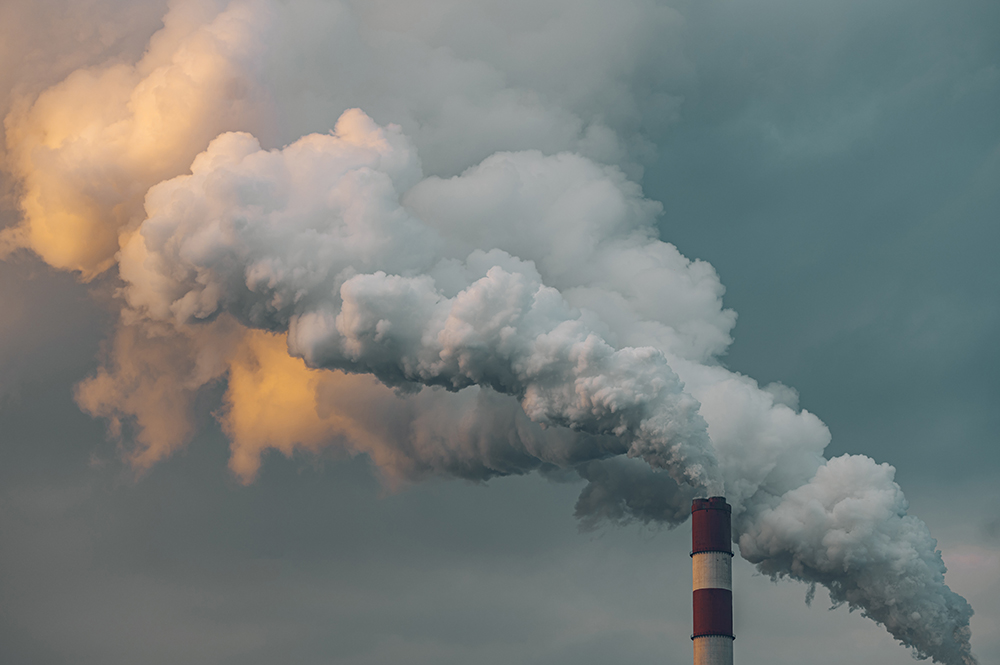 Industrial smokestacks releasing emissions into the atmosphere.