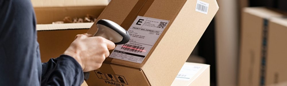 Hands,Scanning,Barcode,On,Delivery,Parcel.,Worker,Scan,Barcode,Of