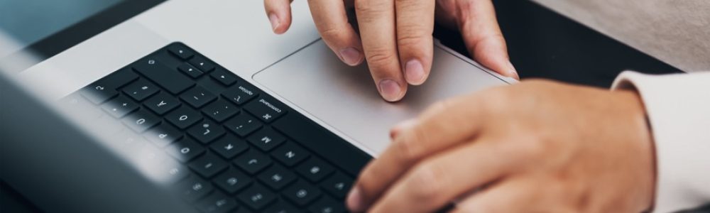 closeup of hands typing on a notebook, keyboard
